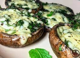 Eswatini Food - Emakhowe(mushrooms) with umbidvo (spinach) rolls covered in white sauce